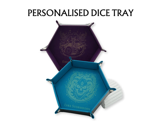 Three hexagonal dice trays in purple, teal, and white, each featuring an engraved skull and dragon emblem, with the text 'PERSONALISED DICE TRAY' above them on a white background.