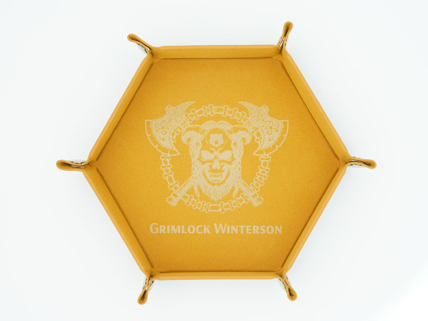 A hexagonal golden-yellow tray featuring a white printed Grimlock Winterson logo and name in the center, with small metal loops at each corner, shown on a plain white background.